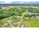 Aerial view of multiple homes nestled among lush trees and overlooking a serene lake at 9231 E Poynter Dr, Morgantown, IN 46160