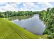 Scenic aerial view of a tranquil lake surrounded by green landscape and lush greenery at 9231 E Poynter Dr, Morgantown, IN 46160