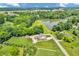 Stunning aerial view of a home on a large lot with mature trees and a private lake at 9231 E Poynter Dr, Morgantown, IN 46160