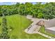 Aerial view of property highlighting a spacious backyard, deck, lush greenery, and an outbuilding at 9231 E Poynter Dr, Morgantown, IN 46160