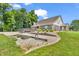 Backyard featuring a deck, patio area, garden beds, and well-manicured landscaping with beautiful brick home at 9231 E Poynter Dr, Morgantown, IN 46160
