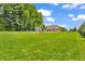 Expansive backyard featuring a storage shed and lovely brick home, surrounded by lush greenery at 9231 E Poynter Dr, Morgantown, IN 46160
