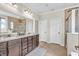 Bright bathroom with double sinks, granite countertops, a large mirror, and a walk-in shower at 9231 E Poynter Dr, Morgantown, IN 46160