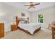 Cozy bedroom with natural light and carpet flooring features a wooden headboard and ceiling fan at 9231 E Poynter Dr, Morgantown, IN 46160