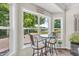 Charming breakfast nook with bar stools and a glass table, with a peaceful view at 9231 E Poynter Dr, Morgantown, IN 46160
