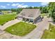 Aerial elevation of a brick house featuring a large lot, well-maintained lawn, and long driveway at 9231 E Poynter Dr, Morgantown, IN 46160
