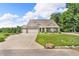 Charming home with a three-car garage, well-maintained lawn, and inviting curb appeal at 9231 E Poynter Dr, Morgantown, IN 46160