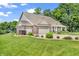 Beautiful home with a lush lawn, mature landscaping, and an attached three-car garage at 9231 E Poynter Dr, Morgantown, IN 46160