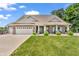 Charming brick home with a well-manicured lawn, attached garage, and a quaint covered porch at 9231 E Poynter Dr, Morgantown, IN 46160