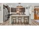 Modern kitchen featuring an island with barstools, stainless steel appliances, and a stylish pendant light at 9231 E Poynter Dr, Morgantown, IN 46160