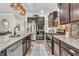 Modern kitchen with granite countertops, stainless steel appliances, and dark wood cabinets at 9231 E Poynter Dr, Morgantown, IN 46160