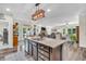 Open concept kitchen island with stone countertops, dual sinks, and connecting living spaces at 9231 E Poynter Dr, Morgantown, IN 46160