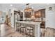 Modern kitchen with an island, bar seating, stainless steel appliances, and hardwood floors at 9231 E Poynter Dr, Morgantown, IN 46160