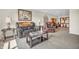 Carpeted living room featuring comfortable leather furniture and rustic decor at 9231 E Poynter Dr, Morgantown, IN 46160