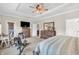 Large main bedroom with a ceiling fan, carpet flooring, and a wooden dresser and TV at 9231 E Poynter Dr, Morgantown, IN 46160