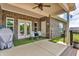 Covered patio featuring a brick accent wall, seating area, and a ceiling fan for added comfort in outdoor living at 9231 E Poynter Dr, Morgantown, IN 46160