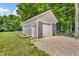 Exterior of a shed featuring gray siding, white trim, and a garage door at 9231 E Poynter Dr, Morgantown, IN 46160