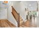 Open staircase features hardwood floors, carpeted steps, and a view into the kitchen at 9231 E Poynter Dr, Morgantown, IN 46160