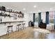 Finished basement boasting a bar area, seating, and natural light at 9508 Oakley Dr, Indianapolis, IN 46260