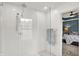 Bright bathroom showcasing a glass shower with rainfall showerhead, leading to a bedroom with paneled wall at 9508 Oakley Dr, Indianapolis, IN 46260