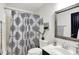 Bathroom featuring a patterned shower curtain, a modern vanity, and a decorative mirror at 9508 Oakley Dr, Indianapolis, IN 46260