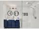 Modern bathroom featuring double vanity, stylish mirrors, and walk-in shower with a built-in seat at 9508 Oakley Dr, Indianapolis, IN 46260