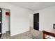 Spacious bedroom with neutral carpet and decor, featuring a black door and a glimpse into a closet at 9508 Oakley Dr, Indianapolis, IN 46260