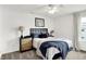 Bright bedroom featuring a bed with blue accents, a unique dresser, and a ceiling fan at 9508 Oakley Dr, Indianapolis, IN 46260