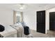 Bedroom featuring a cozy bed with stylish decor, a window seat, and a contrasting black door at 9508 Oakley Dr, Indianapolis, IN 46260