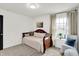 Bright bedroom featuring a daybed with decorative pillows, complemented by a window seat and neutral decor at 9508 Oakley Dr, Indianapolis, IN 46260