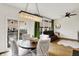 Dining room open to the balcony offers a modern chandelier, wood floors, and bright, airy feel at 9508 Oakley Dr, Indianapolis, IN 46260