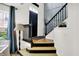 Inviting foyer with hardwood floors, and a staircase with black banister at 9508 Oakley Dr, Indianapolis, IN 46260