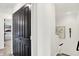 Hallway with staircase and closet featuring modern dark-colored doors at 9508 Oakley Dr, Indianapolis, IN 46260
