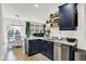 This modern kitchen features stainless steel appliances, floating shelves, and a convenient island sink at 9508 Oakley Dr, Indianapolis, IN 46260