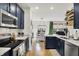 Modern kitchen features navy cabinets, stainless steel appliances, white subway tile and quartz countertops at 9508 Oakley Dr, Indianapolis, IN 46260