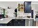 Bright kitchen featuring stainless steel sink, subway tile backsplash, quartz countertop, and open shelving at 9508 Oakley Dr, Indianapolis, IN 46260