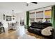Open concept living room featuring a leather couch, ceiling fan, and natural light at 9508 Oakley Dr, Indianapolis, IN 46260