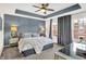 Spacious main bedroom featuring a tray ceiling, a ceiling fan, and two windows at 9508 Oakley Dr, Indianapolis, IN 46260