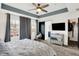 Bright main bedroom features a tray ceiling, stylish decor, and two large windows at 9508 Oakley Dr, Indianapolis, IN 46260