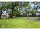Large, grassy backyard with mature trees and plenty of space for activities at 9526 Burrwood Ct, Indianapolis, IN 46235