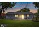 Image shows the back of the house with gray siding and a grassy backyard at 9526 Burrwood Ct, Indianapolis, IN 46235
