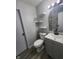 Updated bathroom featuring a modern vanity, stylish mirror, and floating shelves at 9526 Burrwood Ct, Indianapolis, IN 46235