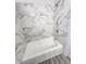 Renovated bathroom featuring marble-style tile and new fixtures at 9526 Burrwood Ct, Indianapolis, IN 46235