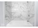 Bathroom boasts a white tub and marble tile surround at 9526 Burrwood Ct, Indianapolis, IN 46235