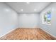 Inviting bedroom showcasing hardwood floors, natural light, and fresh, white walls at 9526 Burrwood Ct, Indianapolis, IN 46235