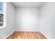 Bedroom features hardwood floors and a bright window at 9526 Burrwood Ct, Indianapolis, IN 46235