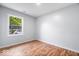 Bedroom with hardwood floors and a large bright window at 9526 Burrwood Ct, Indianapolis, IN 46235
