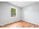Bedroom features hardwood floors and a bright window overlooking the front yard at 9526 Burrwood Ct, Indianapolis, IN 46235