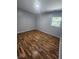 Bedroom featuring a light gray wall and warm, natural wood-toned floors for a cozy, inviting space at 9526 Burrwood Ct, Indianapolis, IN 46235