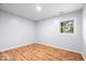 Bedroom with hardwood floors and natural light from the window at 9526 Burrwood Ct, Indianapolis, IN 46235